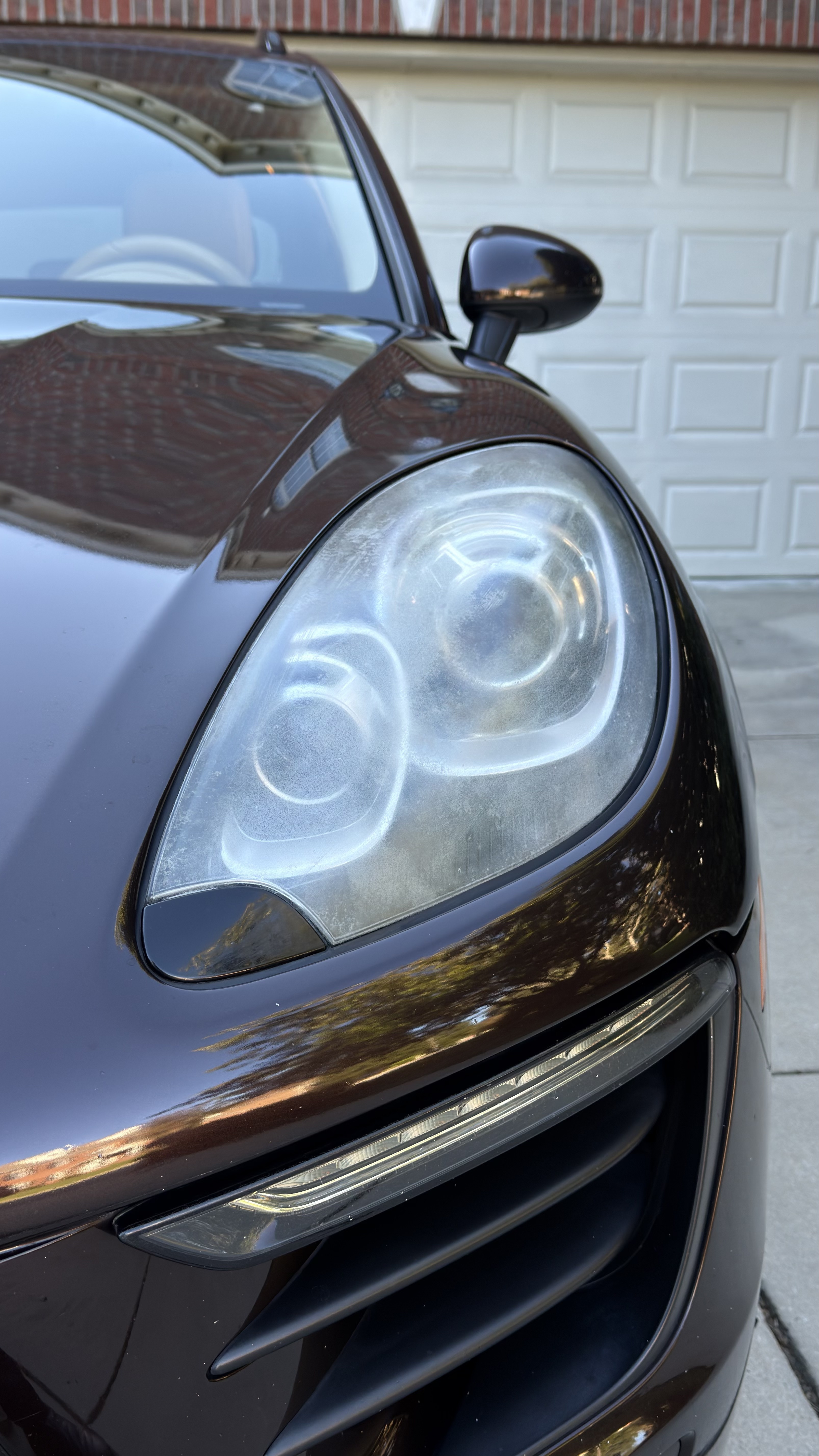 Cloudy 2016 Porsche Macan headlight before restoration